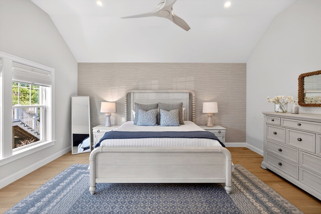 42 Cobblestone Circle Mashpee, MA 02649 - Photo 13 of 40 a spacious bedroom with a bed and wooden floor