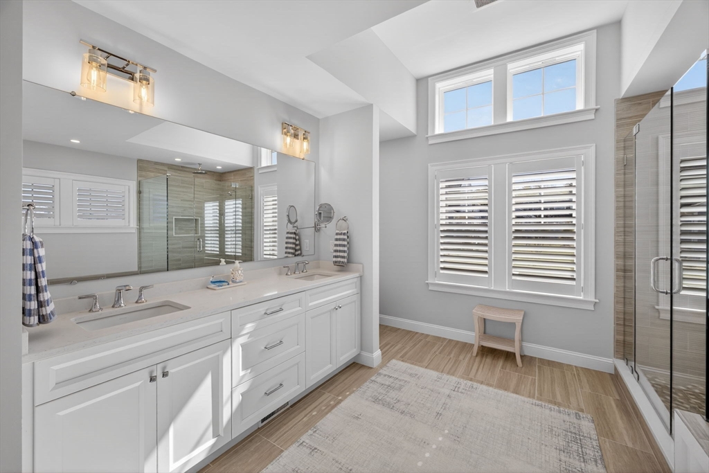 42 Cobblestone Circle Mashpee, MA 02649 - Photo 15 of 40 a spacious bathroom with a double vanity sink a mirror and a bathtub