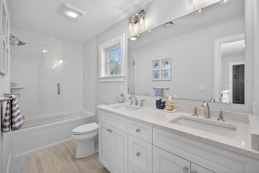 42 Cobblestone Circle Mashpee, MA 02649 - Photo 19 of 40 a bathroom with a toilet a sink a mirror a bathtub and vanity