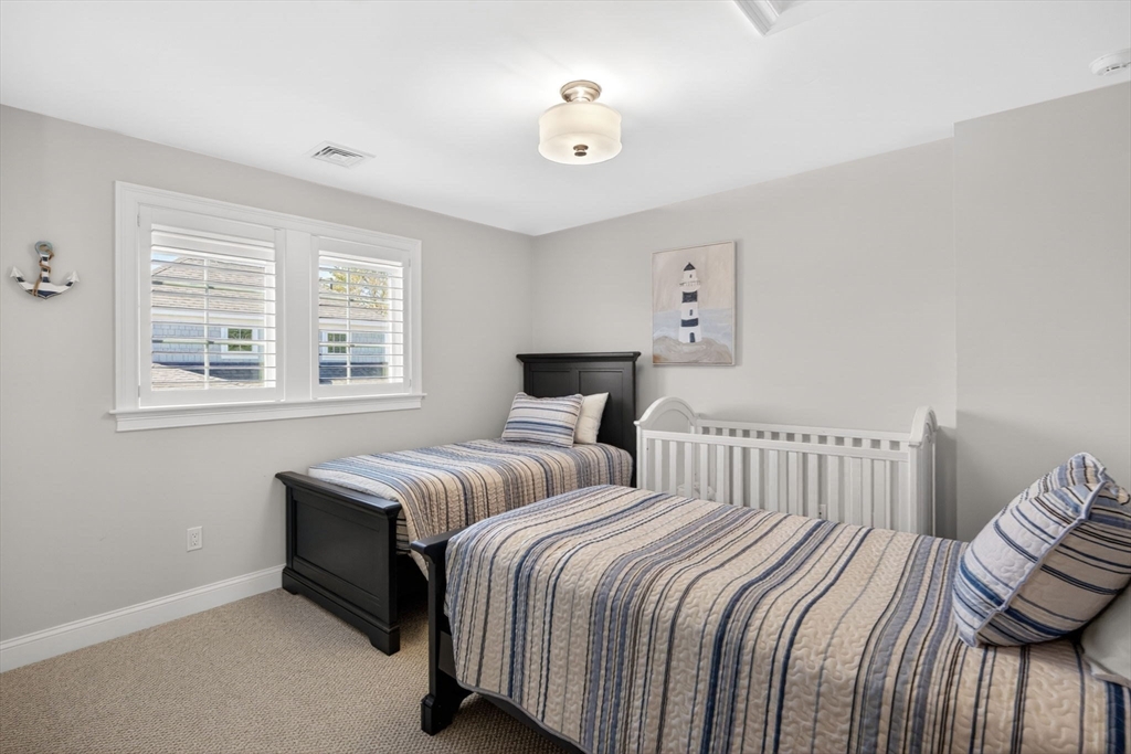 42 Cobblestone Circle Mashpee, MA 02649 - Photo 20 of 40 a bedroom with two beds and a window