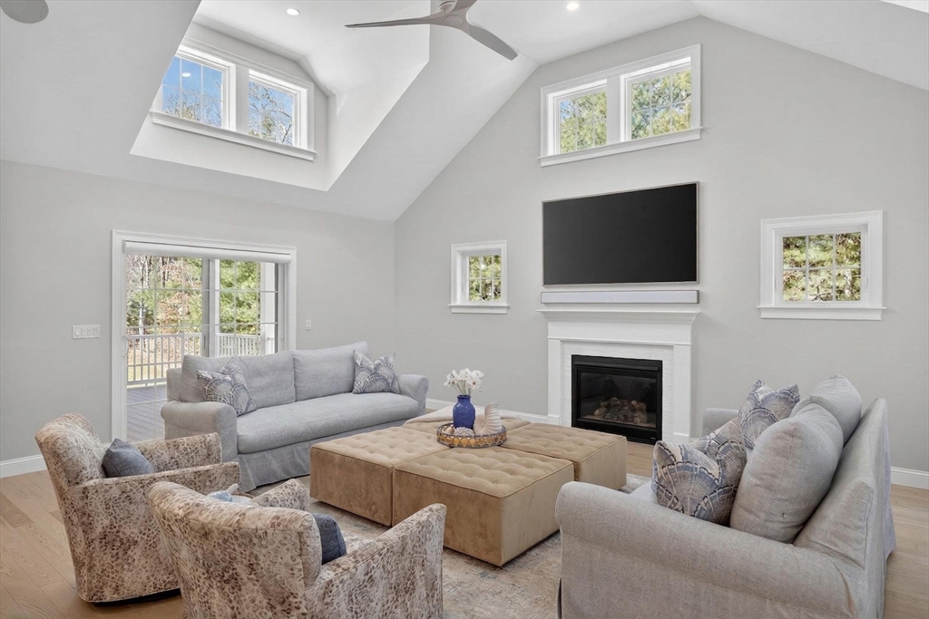 42 Cobblestone Circle Mashpee, MA 02649 - Photo 2 of 40 a living room with furniture a flat screen tv and a fireplace