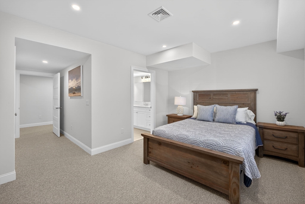 42 Cobblestone Circle Mashpee, MA 02649 - Photo 26 of 40 a bedroom with a bed and cabinets