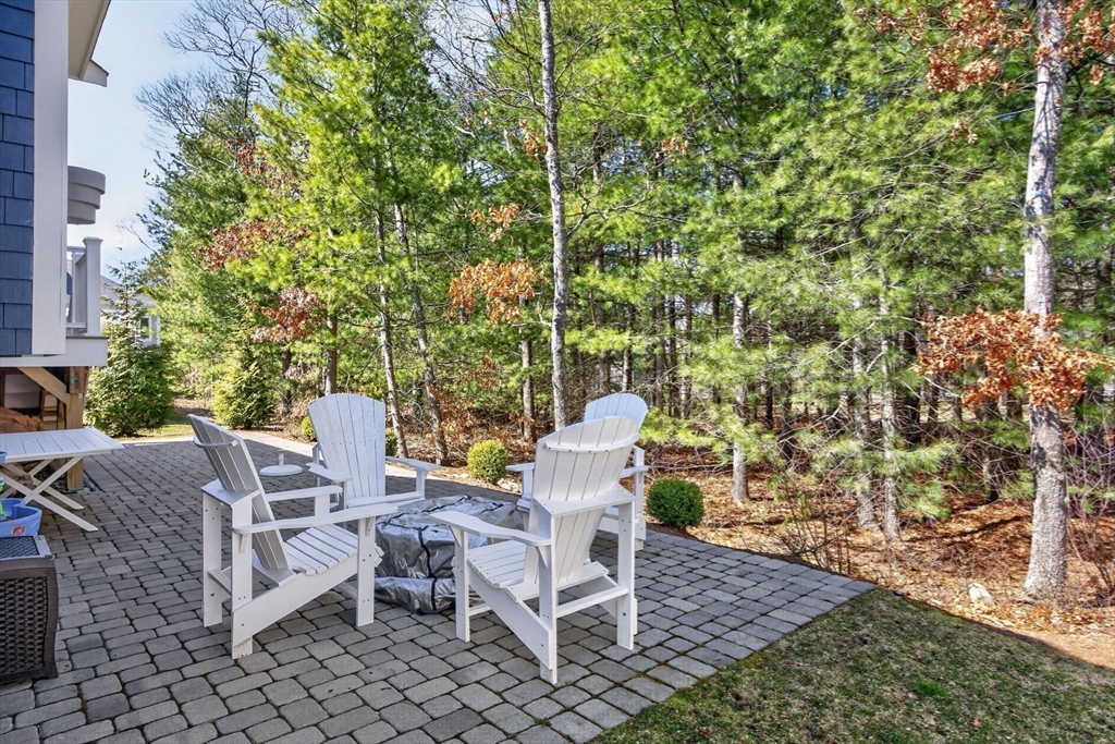 42 Cobblestone Circle Mashpee, MA 02649 - Photo 30 of 40 a view of a patio with table and chairs and potted plants