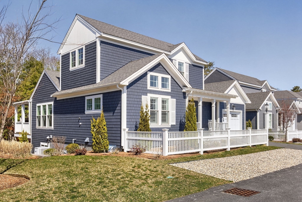 42 Cobblestone Circle Mashpee, MA 02649 - Photo 34 of 40 a front view of a house with a yard