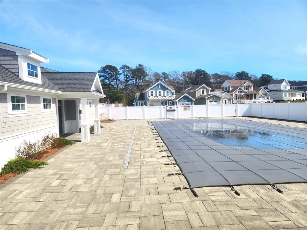 42 Cobblestone Circle Mashpee, MA 02649 - Photo 36 of 40 a view of a swimming pool with a lounge chairs