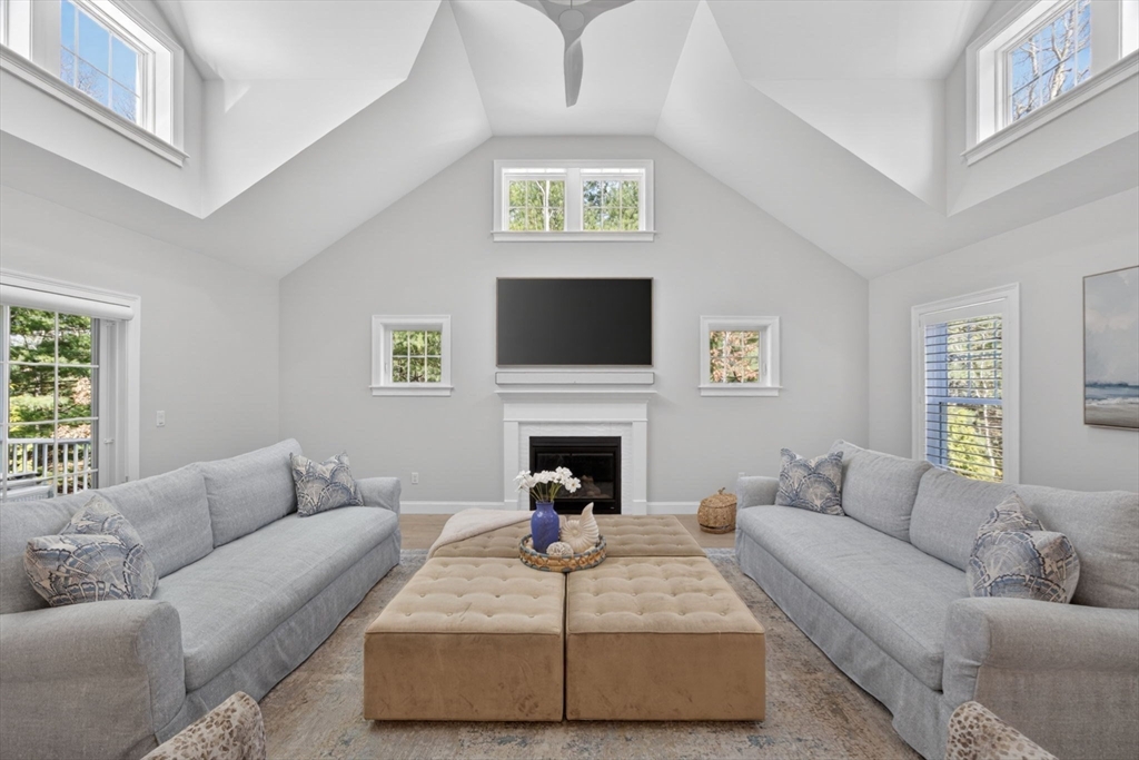 42 Cobblestone Circle Mashpee, MA 02649 - Photo 4 of 40 a living room with furniture a fireplace and a flat screen tv