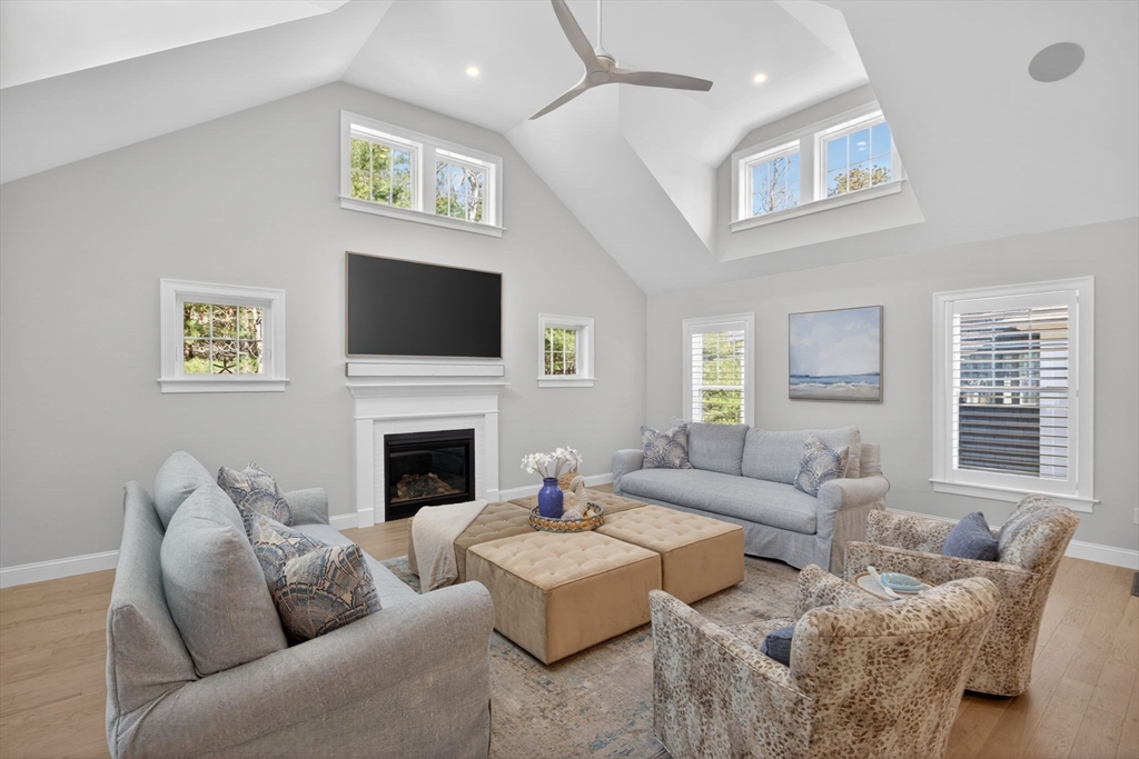42 Cobblestone Circle Mashpee, MA 02649 - Photo 8 of 40 a living room with furniture a fireplace and a flat screen tv