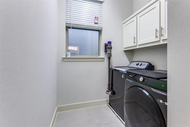a bedroom with a bed lamp and a potted plant