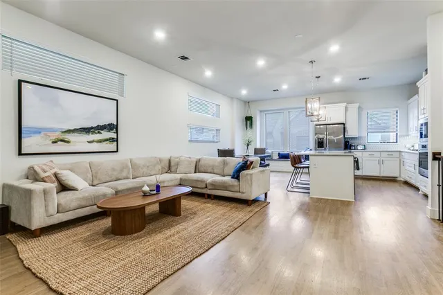 a living room with furniture and wooden floor