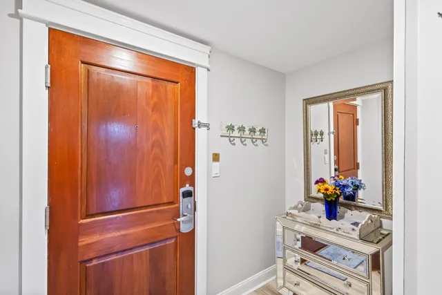 a view of a hallway with wooden floor