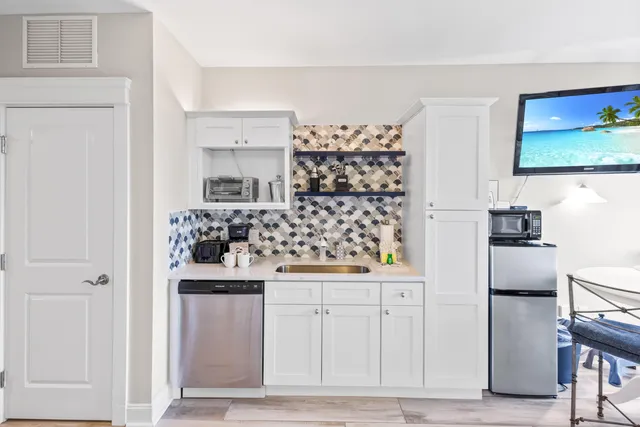 a kitchen with white cabinets and counter space
