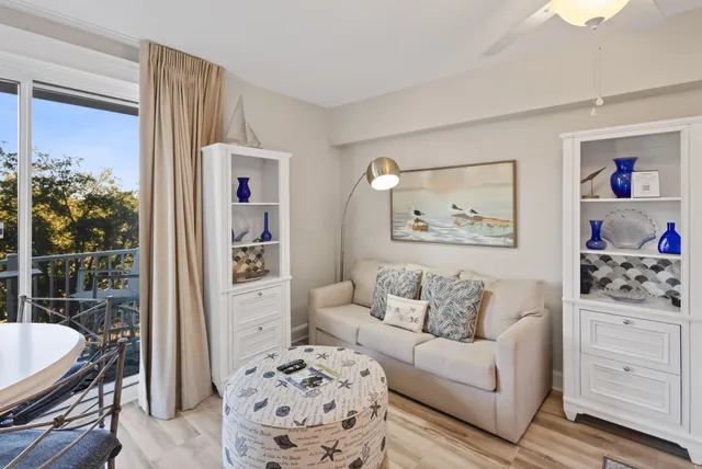 a living room with furniture and a painting on the wall