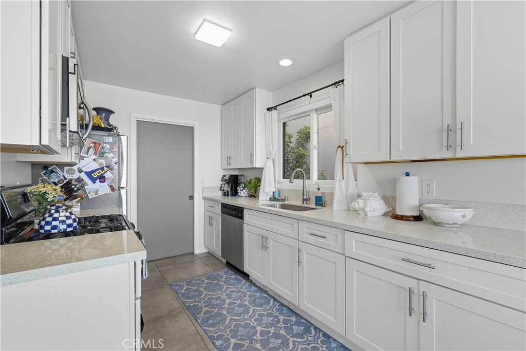202 West Manchester Avenue Playa del Rey, CA 90293 - Photo 7 of 21 a kitchen with sink refrigerator and cabinets