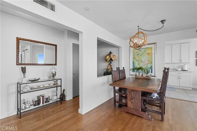a view of a dining room with furniture and a chandelier
