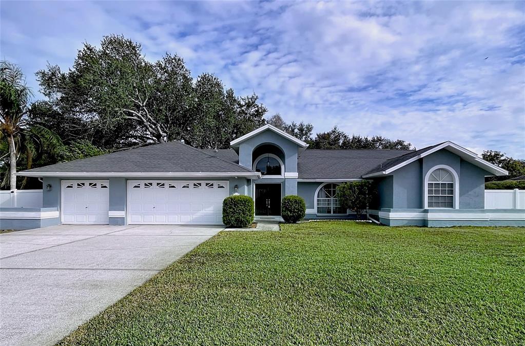 18812 Bascomb Lane Hudson, FL 34667 - Photo 2 of 57 front view of a house with a yard