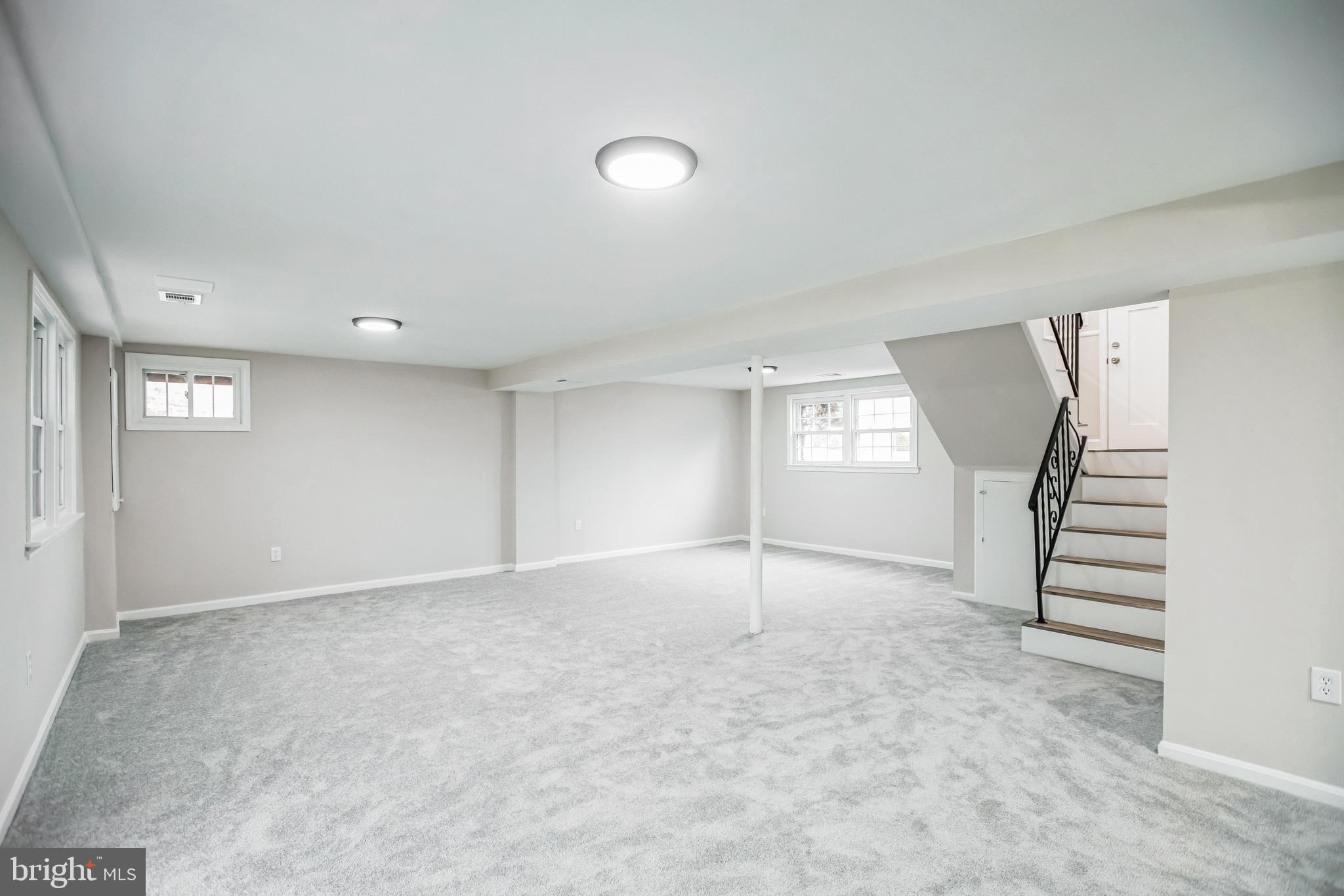 5201 Roblee Drive Upper Marlboro, MD 20772 - Photo 12 of 27 an empty room with windows and stairs
