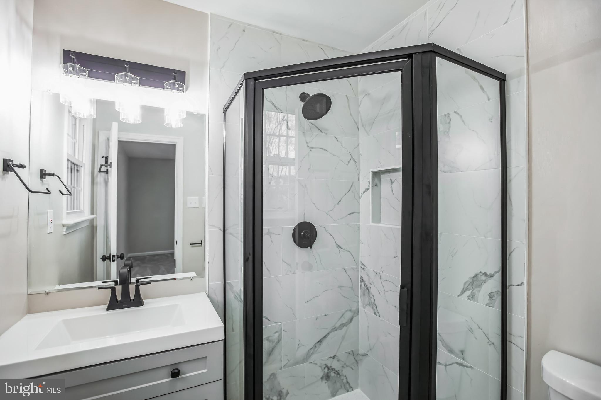 5201 Roblee Drive Upper Marlboro, MD 20772 - Photo 15 of 27 a bathroom with a shower sink and mirror