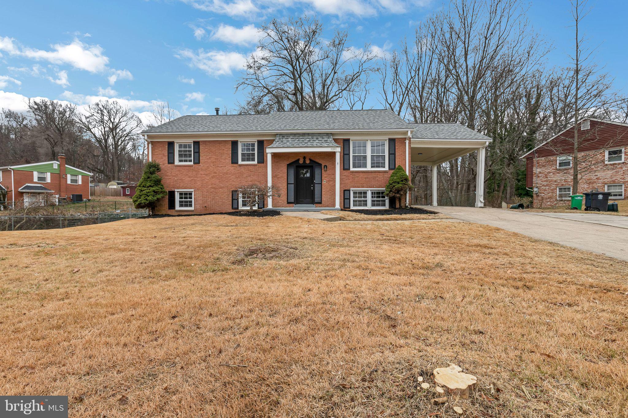 5201 Roblee Drive Upper Marlboro, MD 20772 - Photo 2 of 27 a front view of a house with a yard and garage