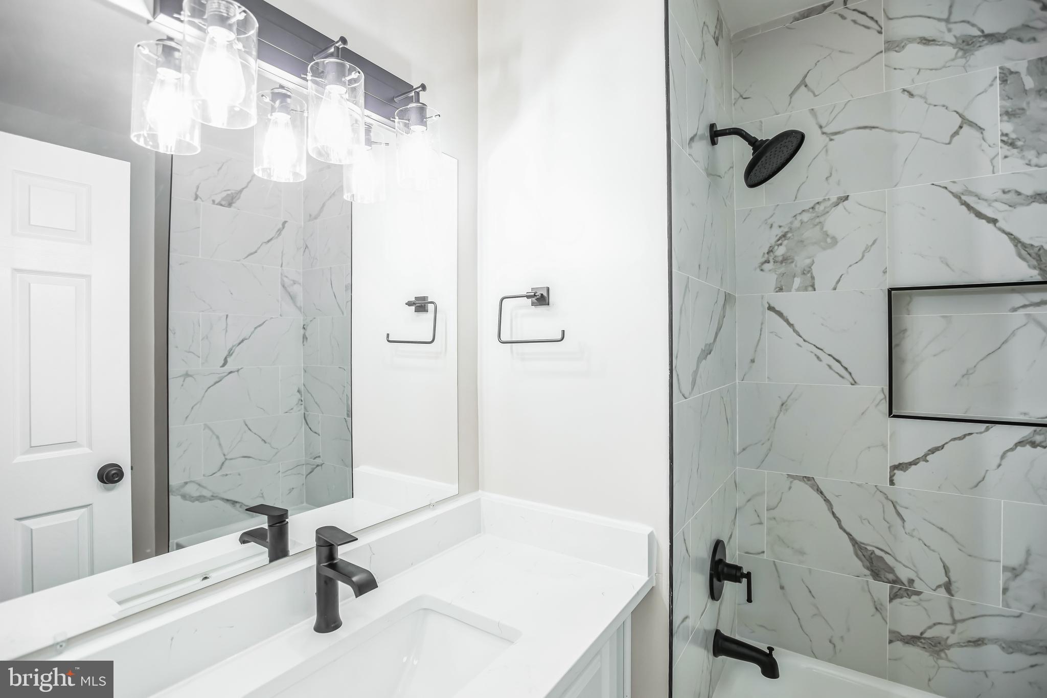 5201 Roblee Drive Upper Marlboro, MD 20772 - Photo 22 of 27 a bathroom with a sink and a shower