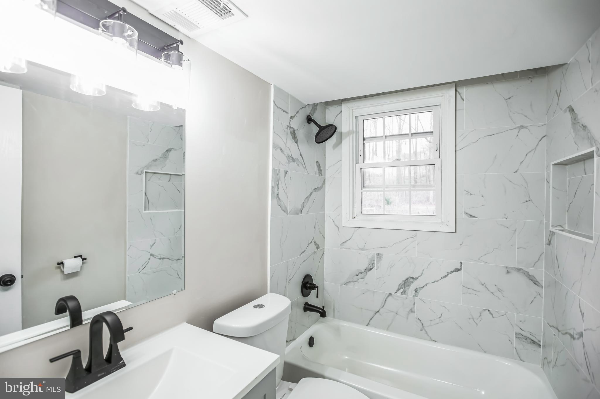 5201 Roblee Drive Upper Marlboro, MD 20772 - Photo 23 of 27 a bathroom with a sink a toilet and a bathtub