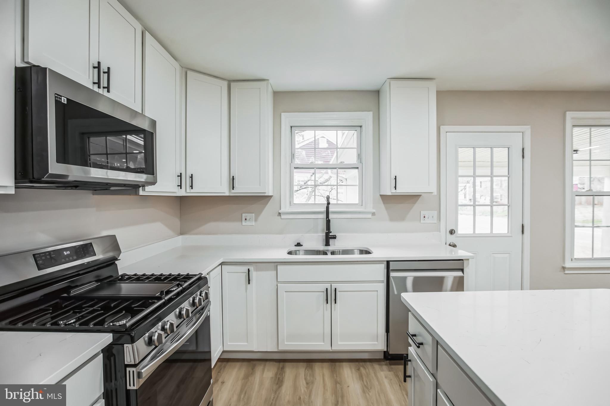 5201 Roblee Drive Upper Marlboro, MD 20772 - Photo 8 of 27 a kitchen with a stove sink and microwave