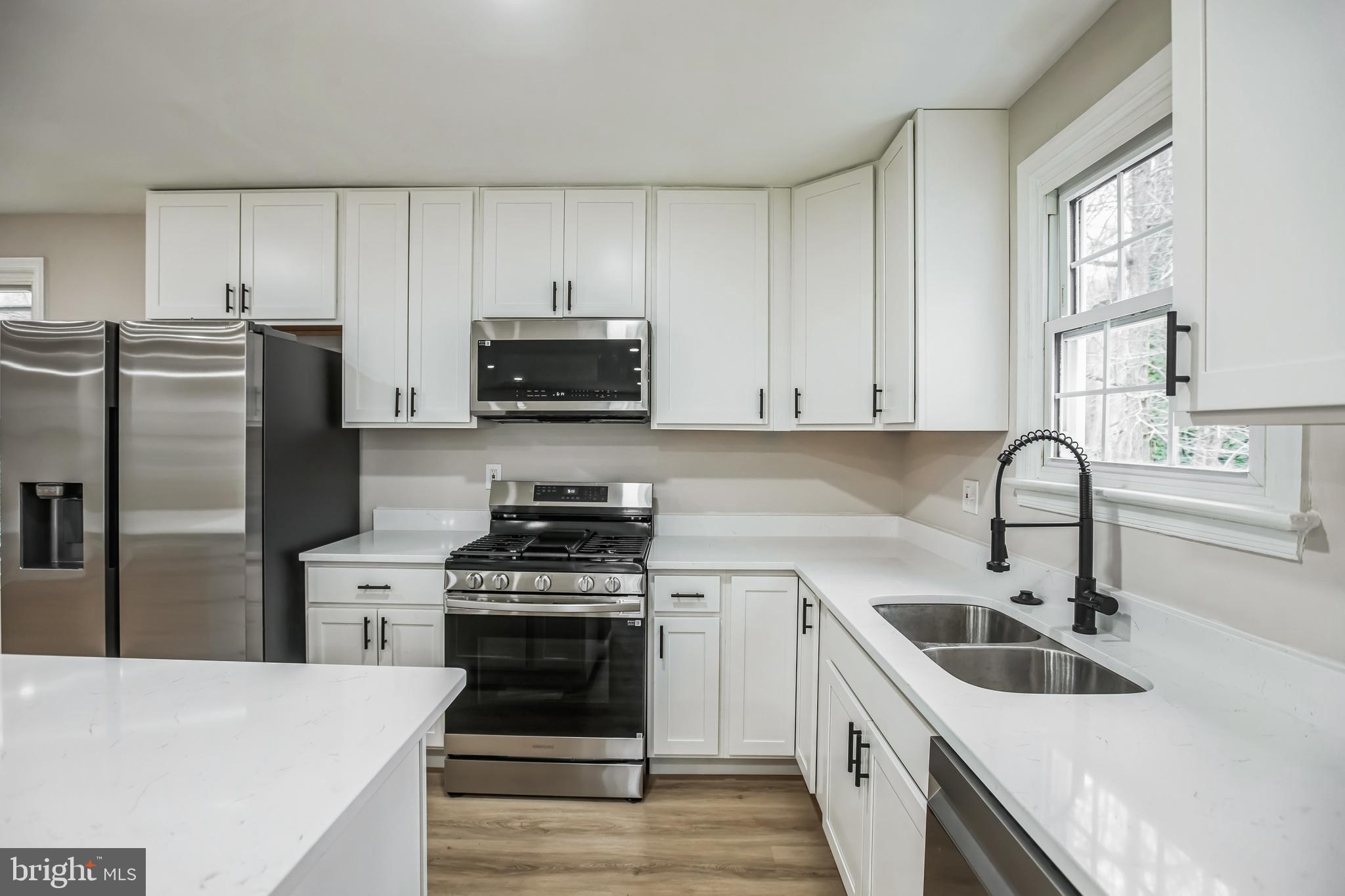 5201 Roblee Drive Upper Marlboro, MD 20772 - Photo 9 of 27 a kitchen with stainless steel appliances a white stove top oven and sink