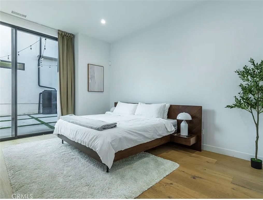 12136 Clarkson Road Los Angeles, CA 90064 - Photo 13 of 23 a bedroom with a bed and a potted plant
