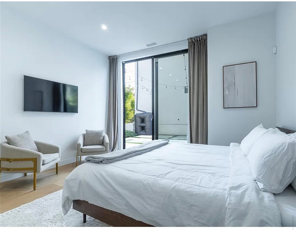 12136 Clarkson Road Los Angeles, CA 90064 - Photo 15 of 23 a bedroom with a bed and a flat screen tv