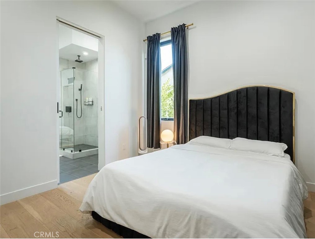 12136 Clarkson Road Los Angeles, CA 90064 - Photo 17 of 23 a bedroom with a bed and a walk in closet