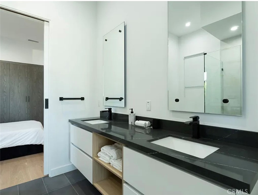 12136 Clarkson Road Los Angeles, CA 90064 - Photo 19 of 23 a bathroom with a sink and a mirror