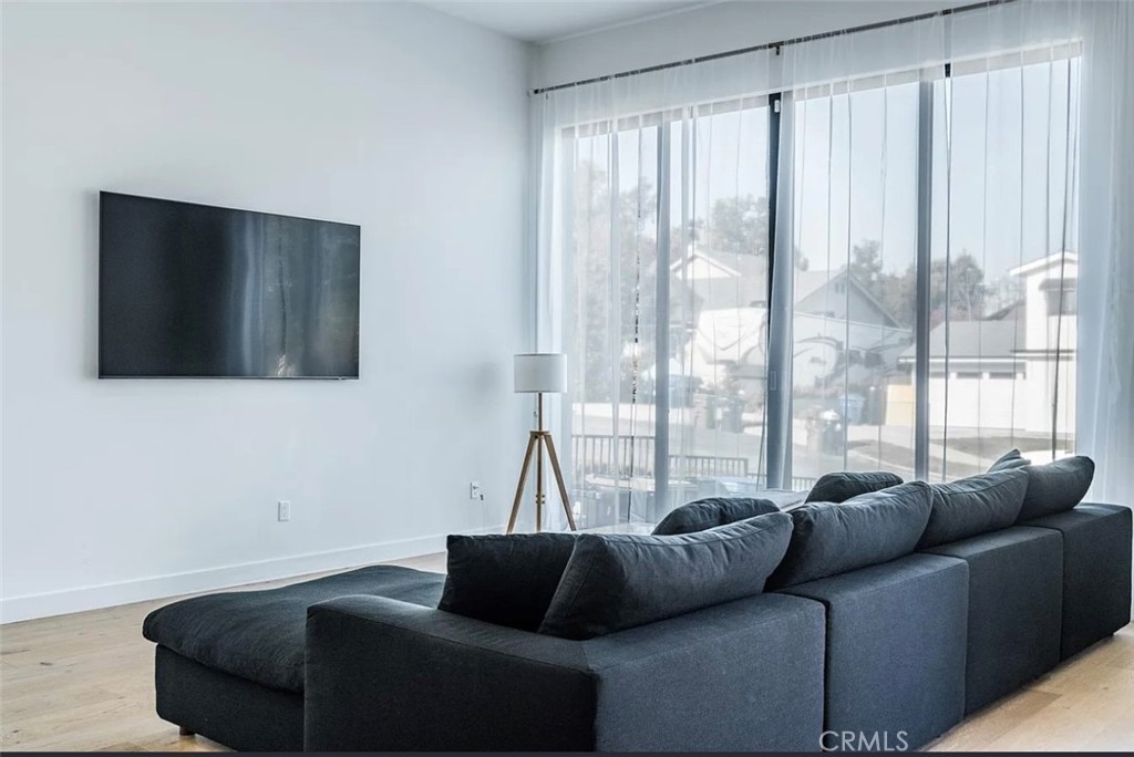 12136 Clarkson Road Los Angeles, CA 90064 - Photo 22 of 23 a living room with furniture and a flat screen tv