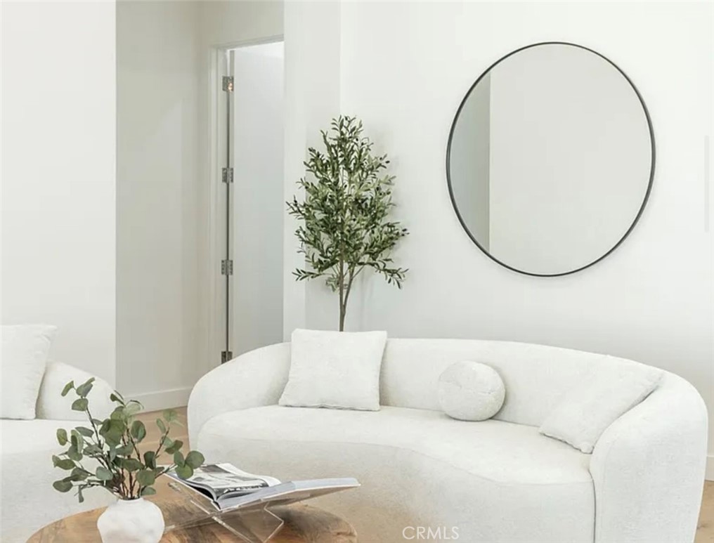 12136 Clarkson Road Los Angeles, CA 90064 - Photo 6 of 23 a living room with a couch and a potted plant