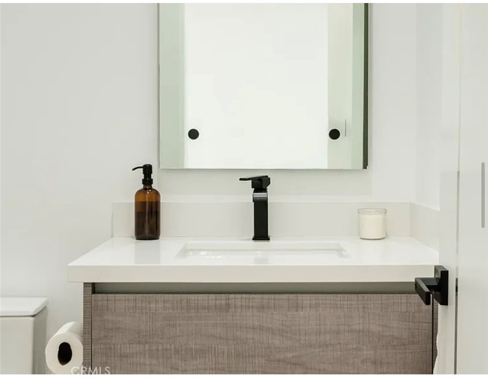 12136 Clarkson Road Los Angeles, CA 90064 - Photo 7 of 23 a bathroom with a sink and a mirror