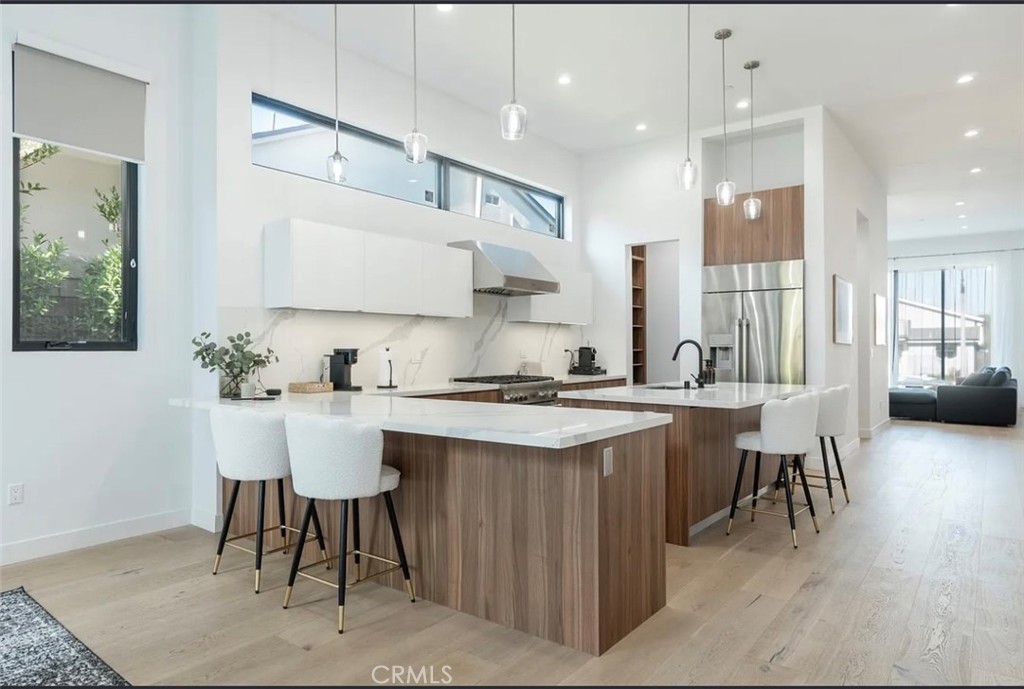 12136 Clarkson Road Los Angeles, CA 90064 - Photo 10 of 23 a kitchen with a sink and chairs