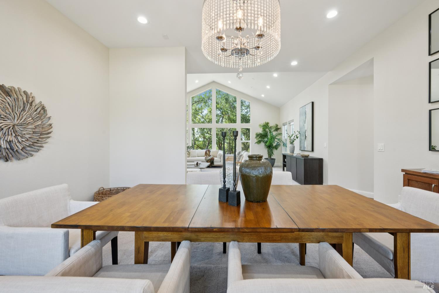 4665 Upper Ridge Road Santa Rosa, CA 95404 - Photo 9 of 71 a view of a dining room with furniture a chandelier and wooden floor