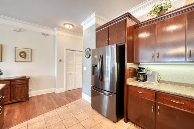 a kitchen with stainless steel appliances granite countertop a refrigerator and a sink