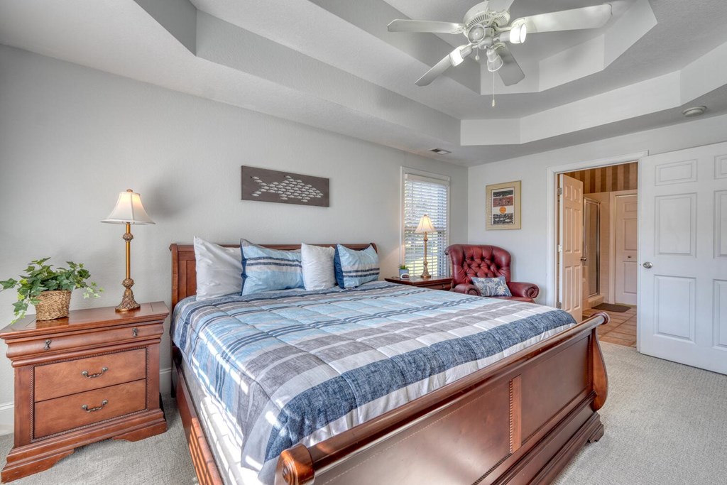 1727 Watercrest Way Young Harris, GA 30582 - Photo 15 of 39 a bedroom with a large bed and a chandelier