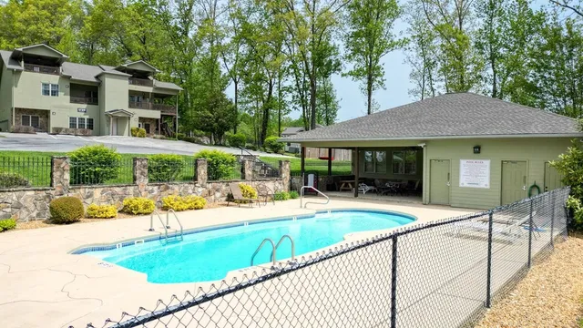 a view of a house with pool and chairs