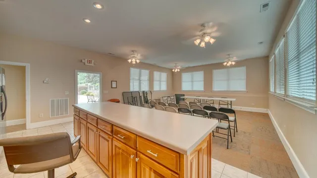 a kitchen with stainless steel appliances granite countertop a stove top oven a sink dishwasher and cabinets with wooden floor