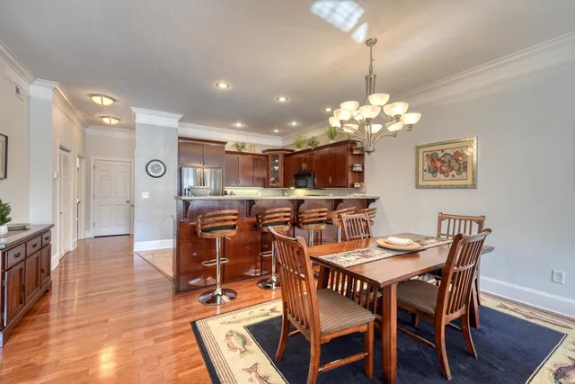 a dining room with furniture and chandelier