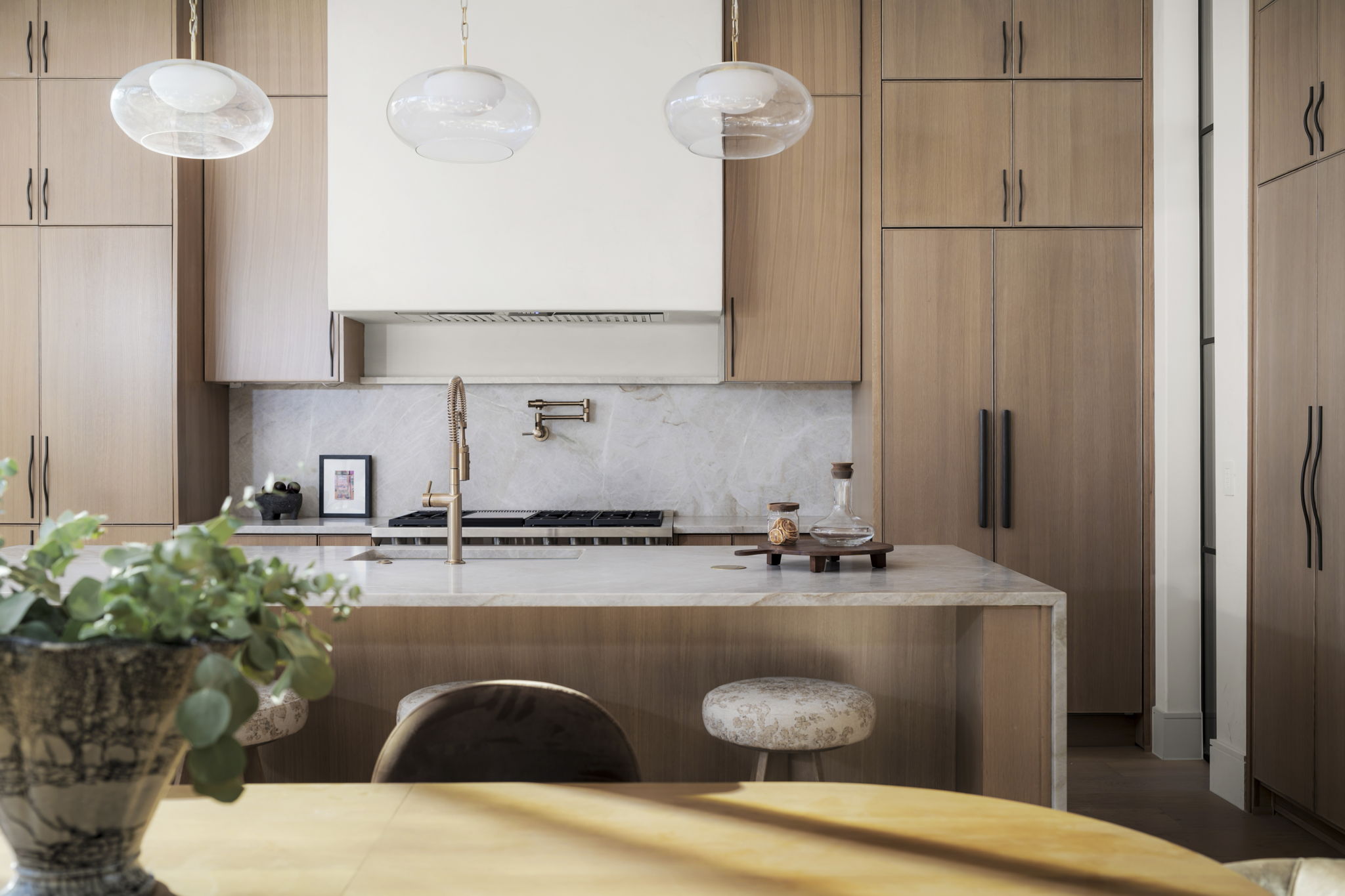 3411 Bridle Path Austin, TX 78703 - Photo 11 of 40 Kitchen with modern cabinets, light stone counters, and a breakfast bar area