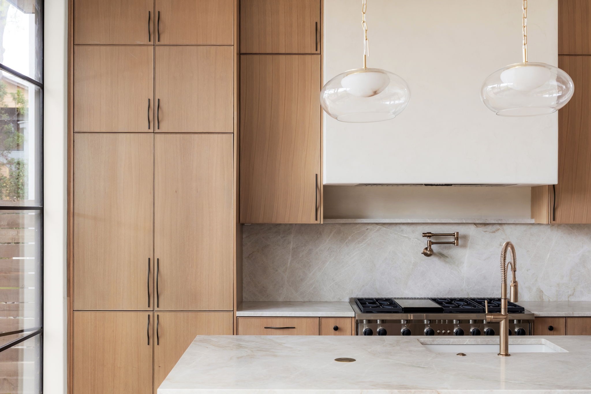 3411 Bridle Path Austin, TX 78703 - Photo 12 of 40 Kitchen featuring light stone counters and modern cabinets