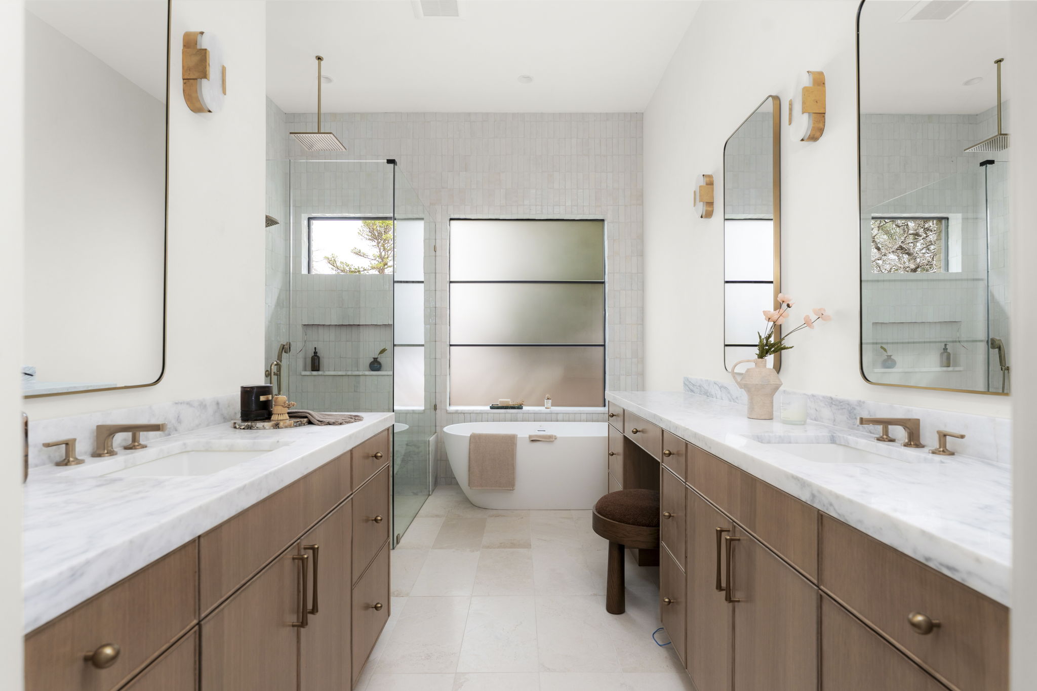 3411 Bridle Path Austin, TX 78703 - Photo 16 of 40 Bathroom with two vanities, a freestanding tub, and a tile shower