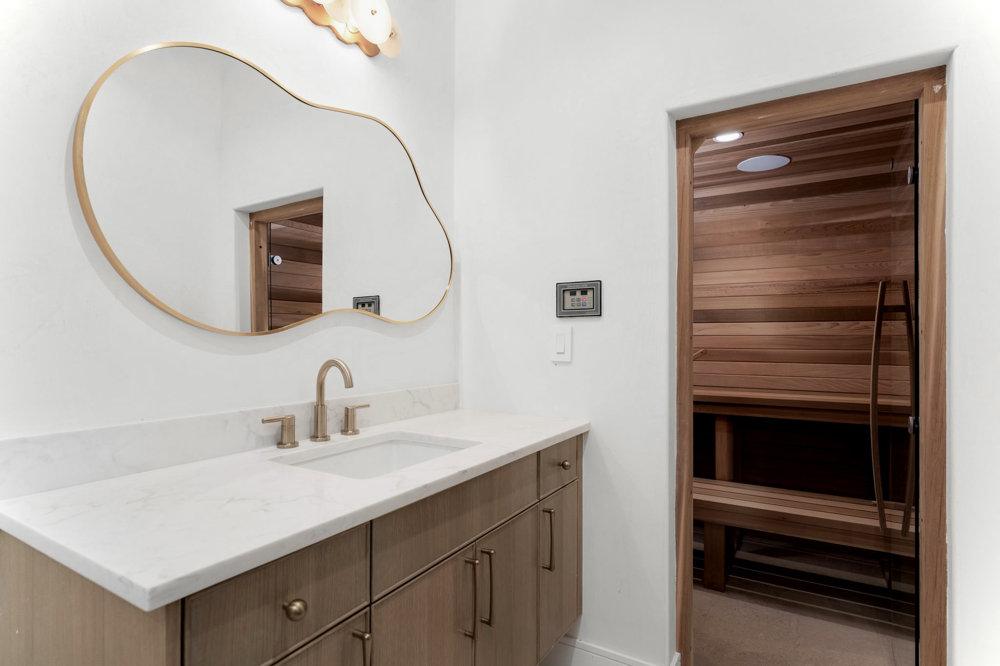 3411 Bridle Path Austin, TX 78703 - Photo 26 of 34 a bathroom with a sink a vanity and a mirror