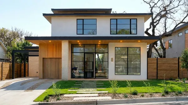 a view of a house with a small yard and plants