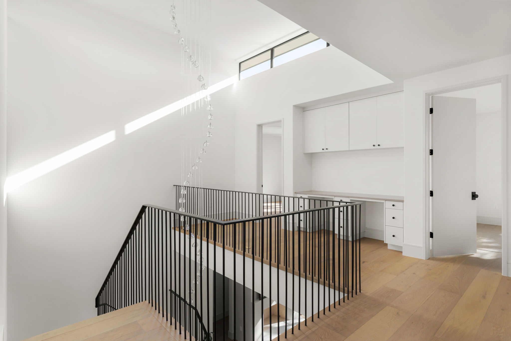 3411 Bridle Path Austin, TX 78703 - Photo 34 of 40 Hallway with light wood-type flooring and a high ceiling