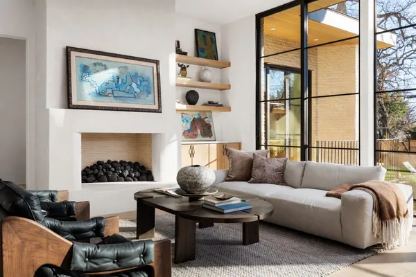 a living room with furniture fireplace and rug