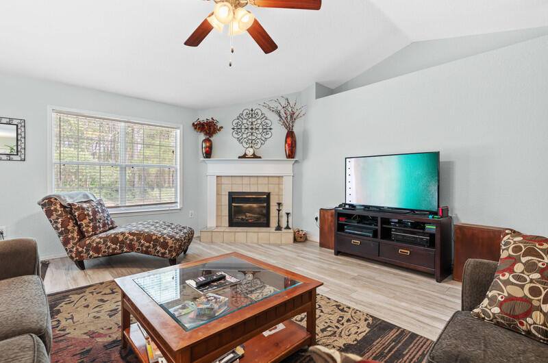 186 Shipwreck Road Santa Rosa Beach, FL 32459 - Photo 11 of 37 a living room with furniture and a fireplace
