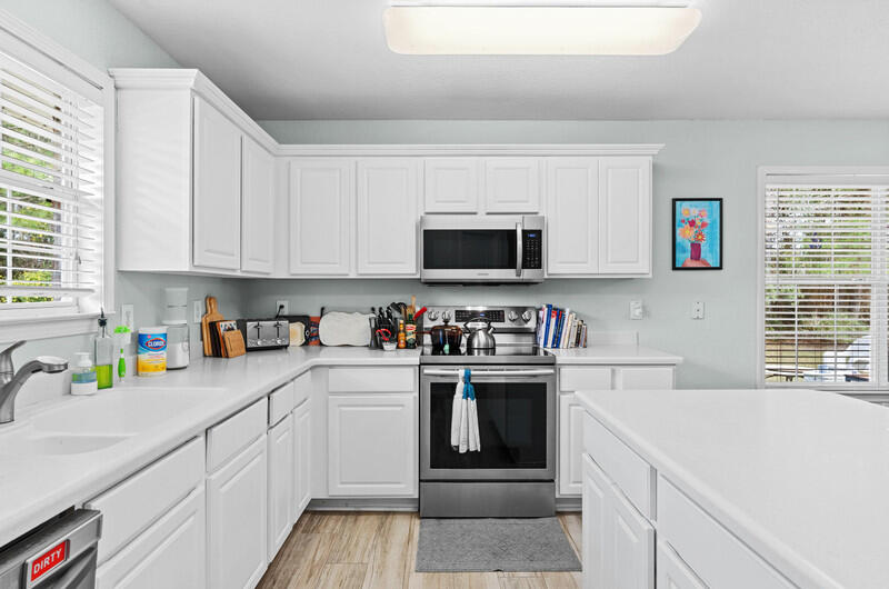 186 Shipwreck Road Santa Rosa Beach, FL 32459 - Photo 26 of 37 a kitchen with stainless steel appliances granite countertop a sink and a stove