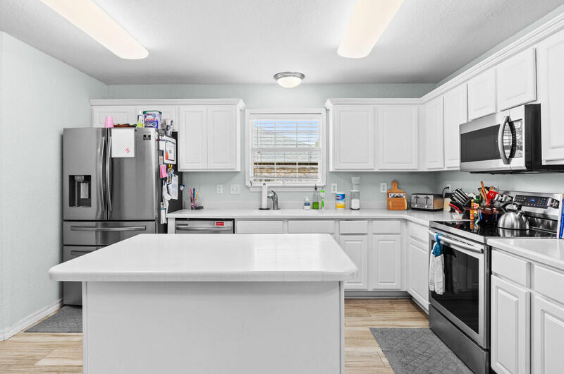 186 Shipwreck Road Santa Rosa Beach, FL 32459 - Photo 27 of 37 a kitchen with stainless steel appliances a refrigerator sink and microwave